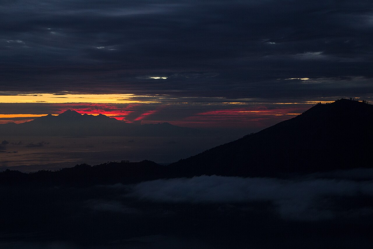 Pre-dawn view from Mount Batur with Mount Rinjani on Lombok on the horizon